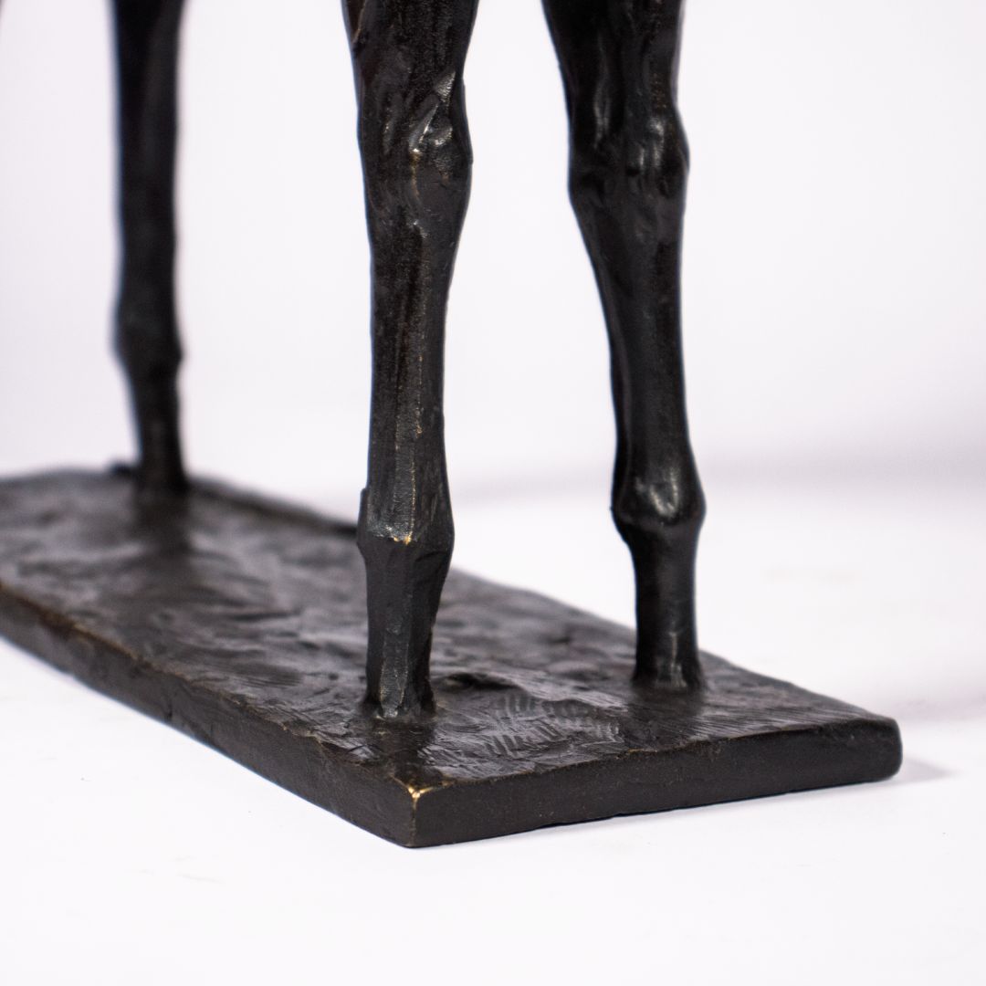 Close-up of feet of bronze sculpture of a fawn deer with dark patina