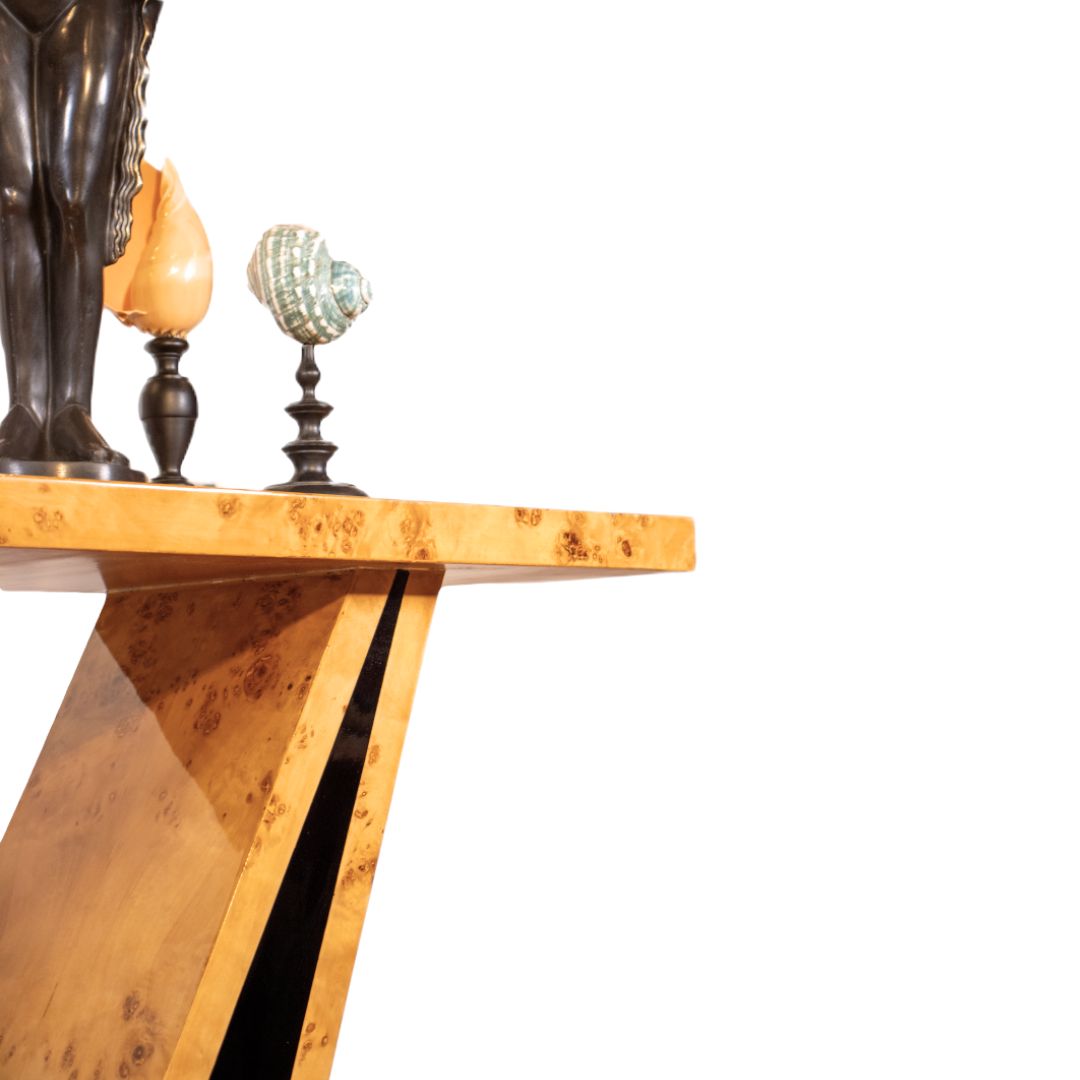 Side view of Art Deco V-shape console table with burl walnut wood and black lacquer base featuring decorative shell and bronze accents, elegant furniture detail