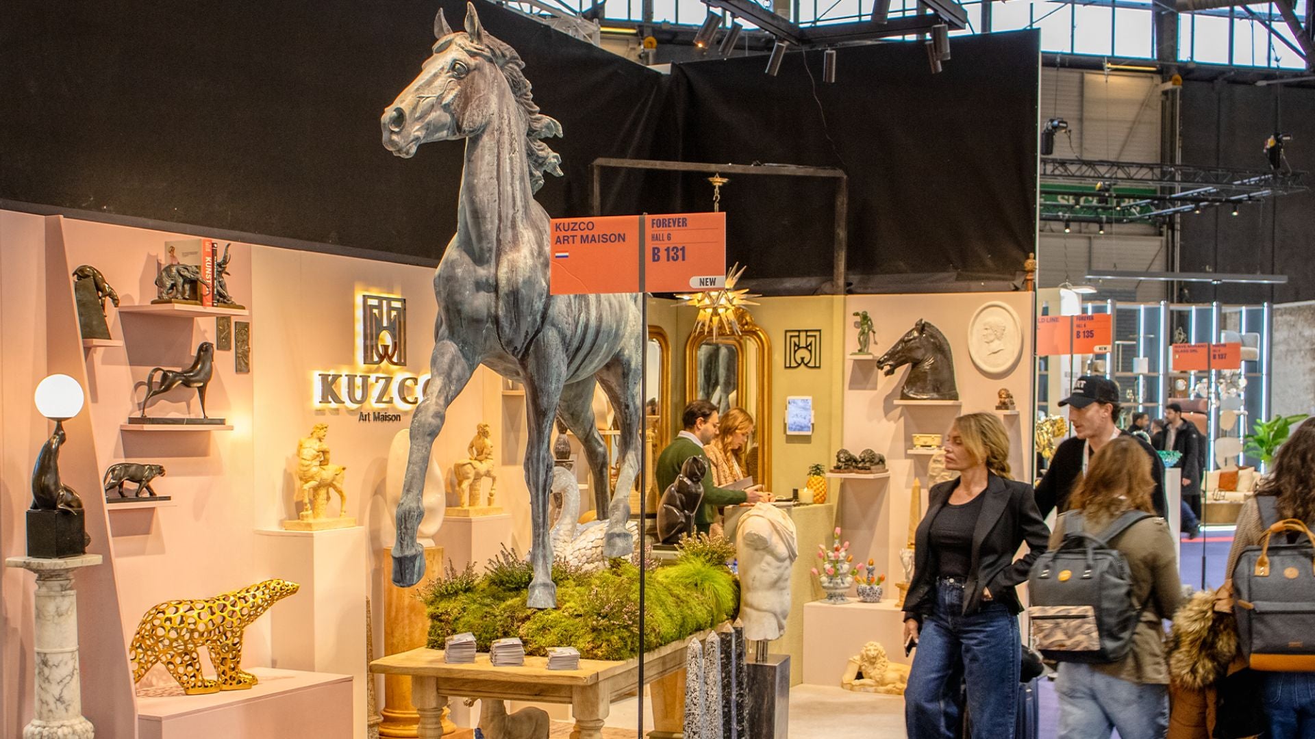 Exhibition booth displaying bronze and marble sculptures in classic antique art at Maison et Objet 2025 with a large horse sculpture and visitors