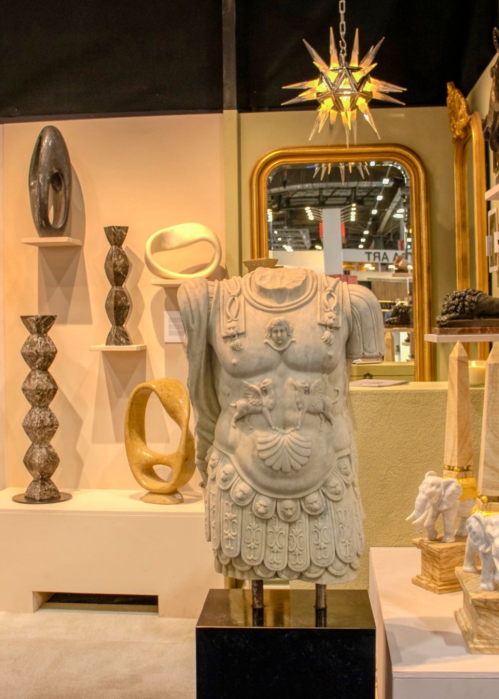 Marble sculpture of a Roman torso displayed at the Maison et Objet interior design fair with decorative accents